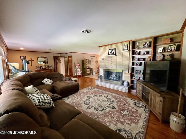 501 W Morgan St, Tipton, MO 65081 - living room with a fireplace, wood finished floors, and ornamental molding