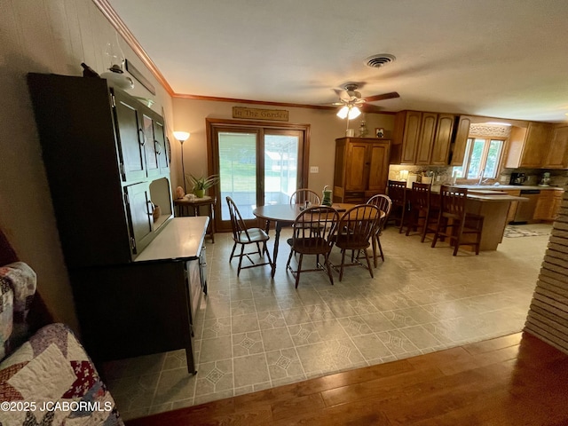 501 W Morgan St, Tipton, MO 65081 - dining room with ceiling fan, light wood-type flooring, and crown molding