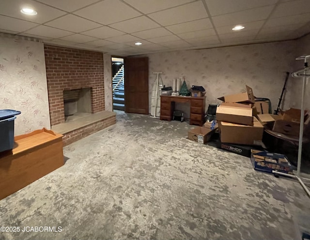 501 W Morgan St, Tipton, MO 65081 - living room featuring a brick fireplace, a drop ceiling, recessed lighting, and wallpapered walls