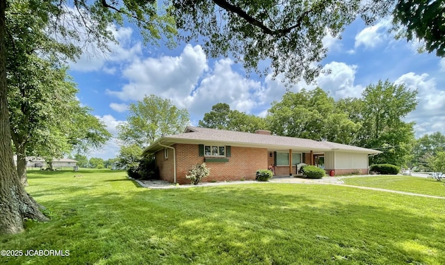 501 W Morgan St, Tipton, MO 65081 - single story home featuring brick siding, a front yard, and a chimney