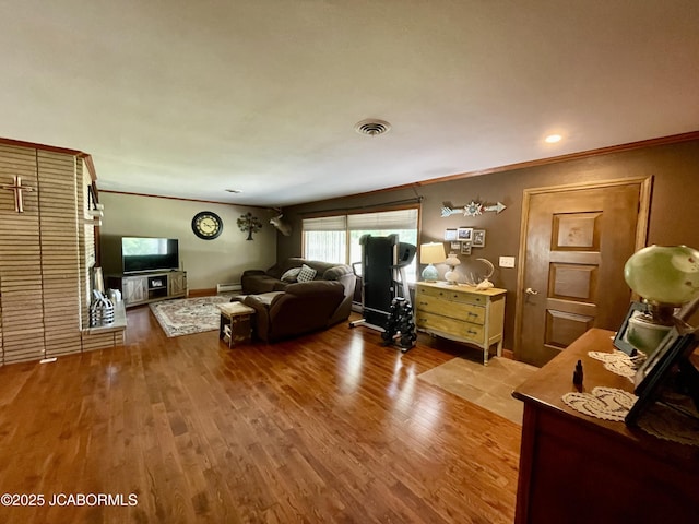 501 W Morgan St, Tipton, MO 65081 - living room with ornamental molding, wood finished floors, and baseboard heating