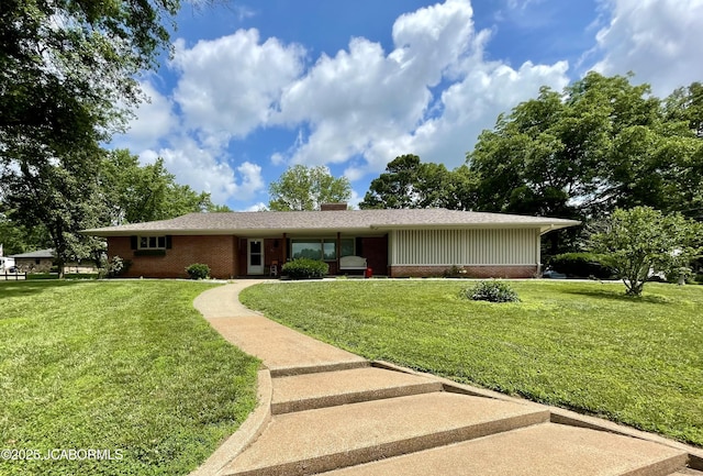 501 W Morgan St, Tipton, MO 65081 - ranch-style home featuring brick siding, a front yard, a chimney, and board and batten siding