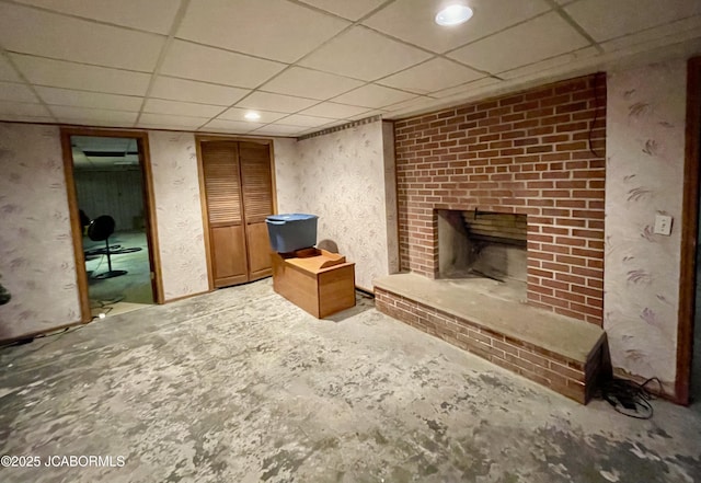 501 W Morgan St, Tipton, MO 65081 - unfurnished living room featuring a fireplace and a drop ceiling
