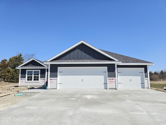 view of front of house with board and batten siding, driveway, and a garage