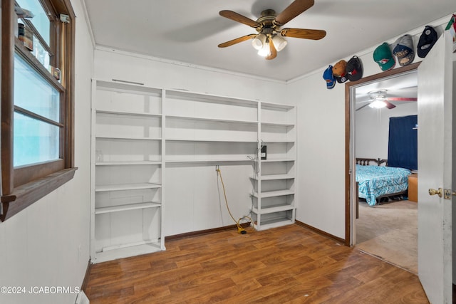 unfurnished bedroom featuring wood-type flooring and ceiling fan