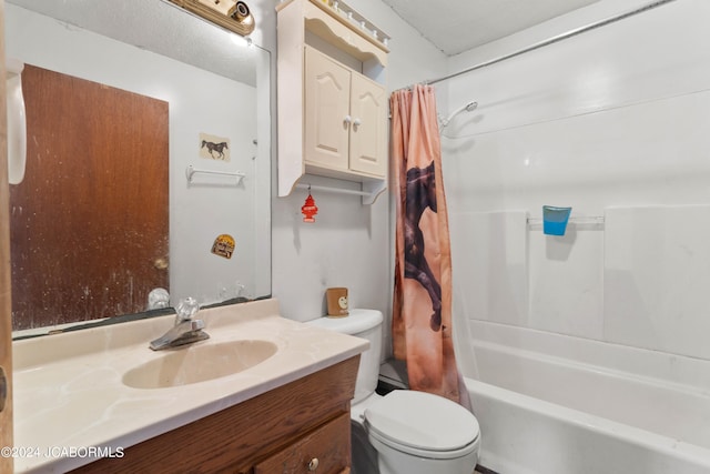 full bathroom with vanity, toilet, shower / bath combo with shower curtain, and a textured ceiling