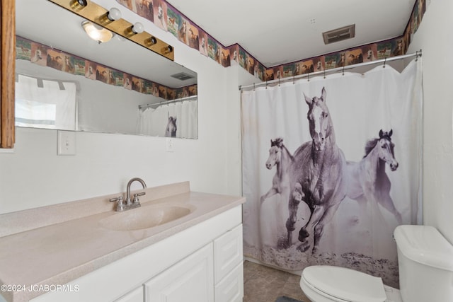 bathroom featuring tile patterned floors, a shower with curtain, vanity, and toilet