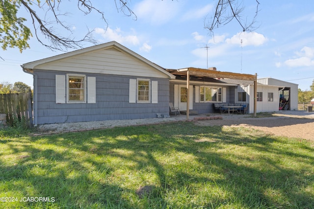 ranch-style home with a front lawn