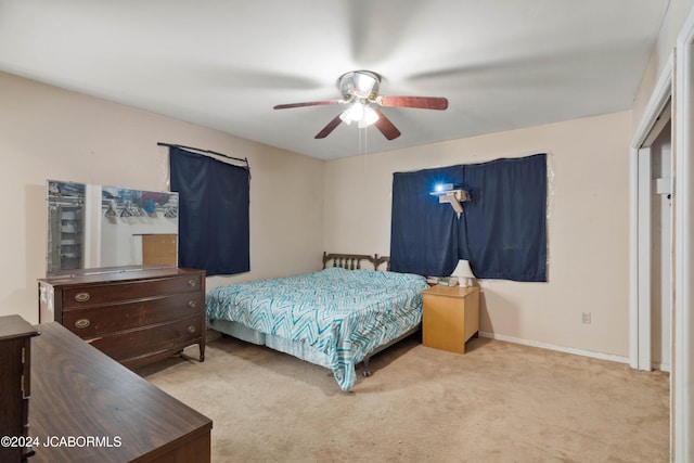 bedroom with light colored carpet and ceiling fan