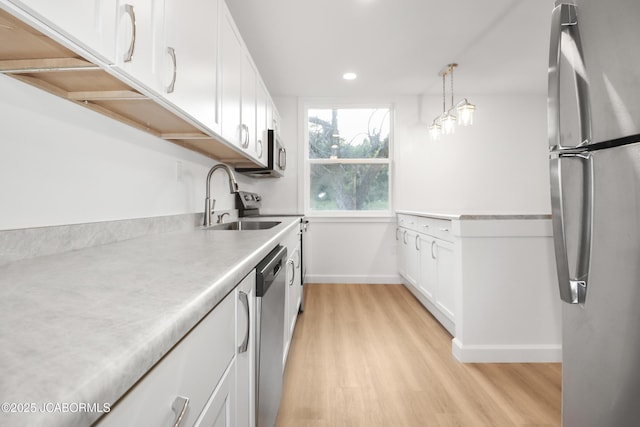 1214 Lynn St, Fulton, MO 65251 - kitchen featuring stainless steel appliances, light wood-style flooring, white cabinets, recessed lighting, and light countertops