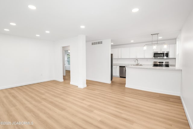 1214 Lynn St, Fulton, MO 65251 - unfurnished living room featuring recessed lighting and light wood-style floors