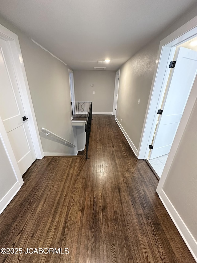 1434 Sunset Lake Rd, Jefferson City, MO 65109 - hallway with baseboards, dark wood-style flooring, and an upstairs landing