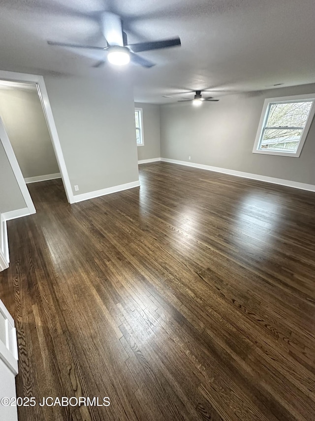 1434 Sunset Lake Rd, Jefferson City, MO 65109 - empty room featuring a ceiling fan, dark wood-type flooring, and baseboards