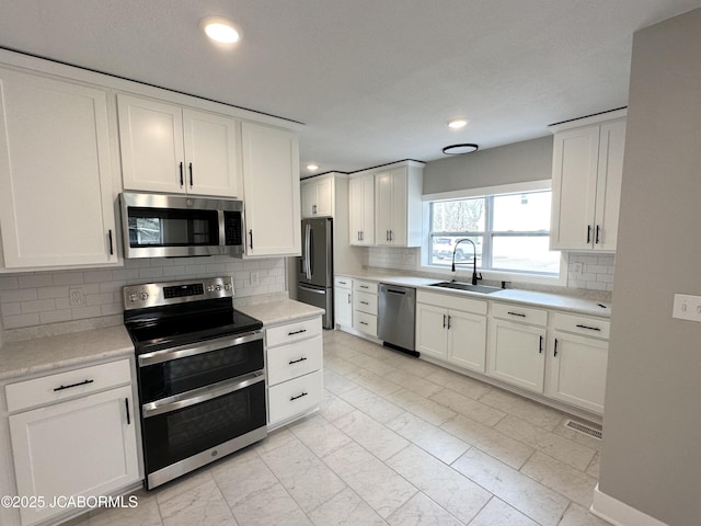 1434 Sunset Lake Rd, Jefferson City, MO 65109 - kitchen with light countertops, visible vents, marble finish floor, appliances with stainless steel finishes, and a sink