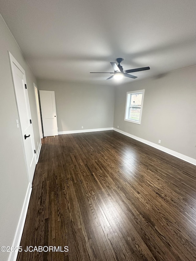 1434 Sunset Lake Rd, Jefferson City, MO 65109 - spare room featuring baseboards, ceiling fan, and dark wood finished floors