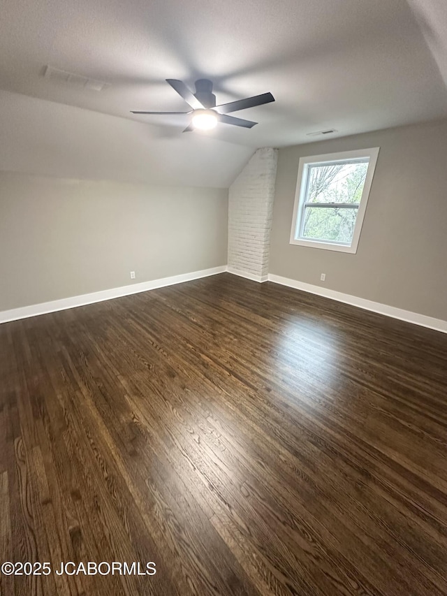 1434 Sunset Lake Rd, Jefferson City, MO 65109 - bonus room with a ceiling fan, dark wood finished floors, lofted ceiling, baseboards, and visible vents