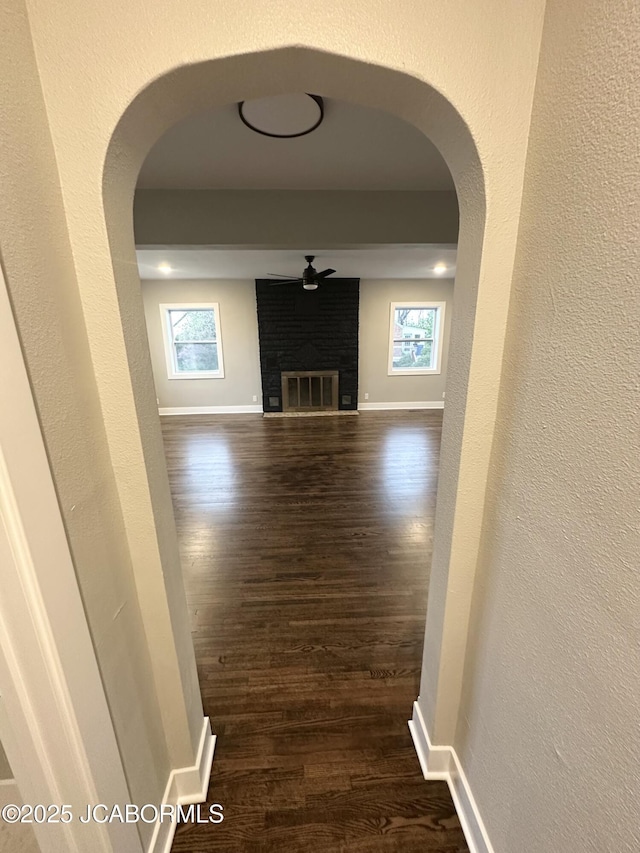 1434 Sunset Lake Rd, Jefferson City, MO 65109 - hallway featuring dark wood finished floors and arched walkways