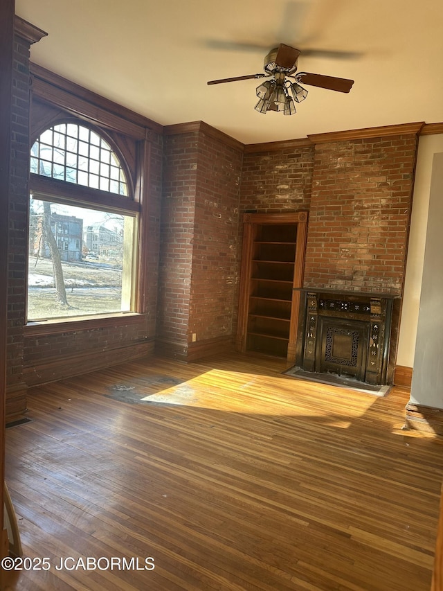 unfurnished living room with ceiling fan and wood-type flooring