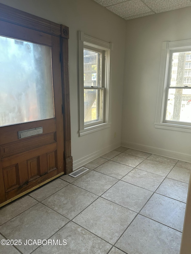 foyer with a drop ceiling