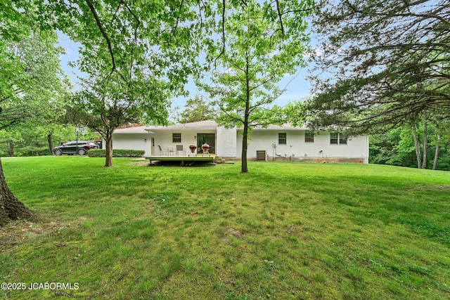 4300 W E Ridge Rd, Columbia, MO 65202 - rear view of house featuring a lawn and central AC
