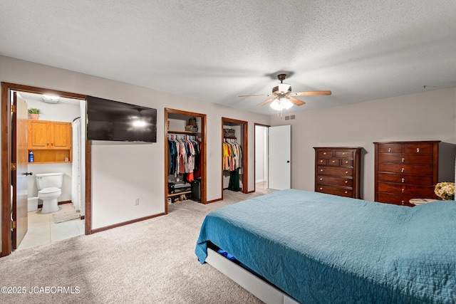 4300 W E Ridge Rd, Columbia, MO 65202 - bedroom with light carpet, baseboards, connected bathroom, a textured ceiling, and ceiling fan