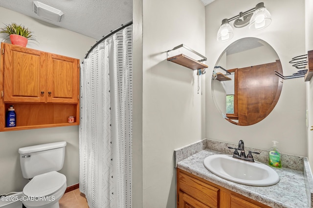4300 W E Ridge Rd, Columbia, MO 65202 - bathroom featuring vanity, toilet, a textured ceiling, tile patterned flooring, and a shower with curtain