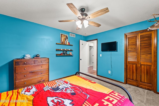 4300 W E Ridge Rd, Columbia, MO 65202 - carpeted bedroom with a closet, ceiling fan, baseboards, and a textured ceiling