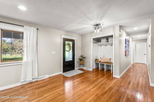 4300 W E Ridge Rd, Columbia, MO 65202 - entrance foyer with light wood-style floors, baseboards, a textured ceiling, and recessed lighting