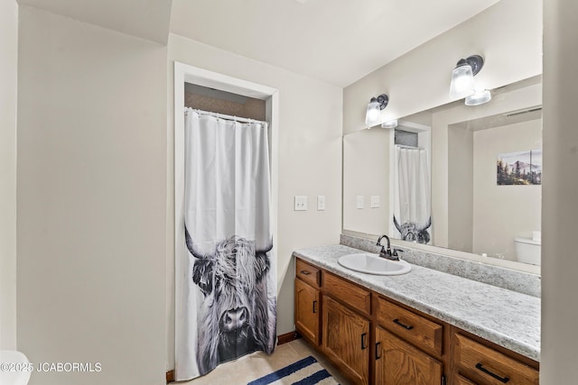 4300 W E Ridge Rd, Columbia, MO 65202 - full bath featuring toilet, vanity, and tile patterned flooring