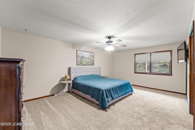 4300 W E Ridge Rd, Columbia, MO 65202 - bedroom with light carpet, baseboards, a ceiling fan, and a textured ceiling