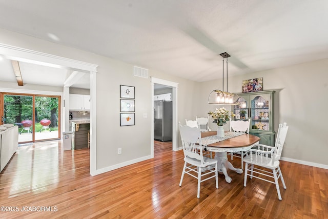 4300 W E Ridge Rd, Columbia, MO 65202 - dining room featuring baseboards, light wood finished floors, and a chandelier