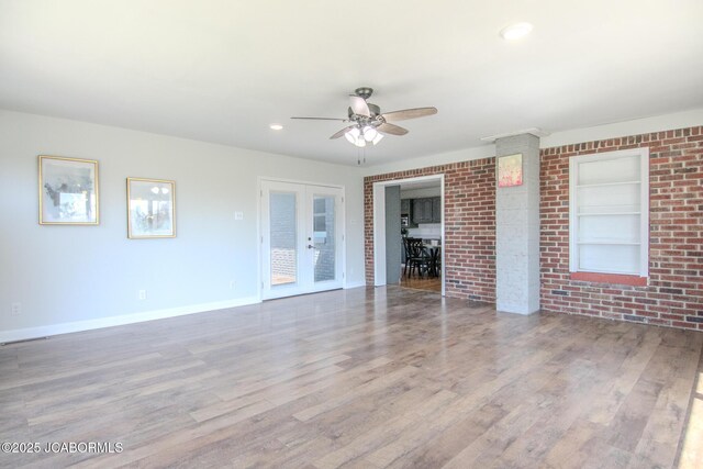 12271 County Road 4037, Holts Summit, MO 65043 - unfurnished living room with ceiling fan, wood finished floors, baseboards, built in features, and french doors