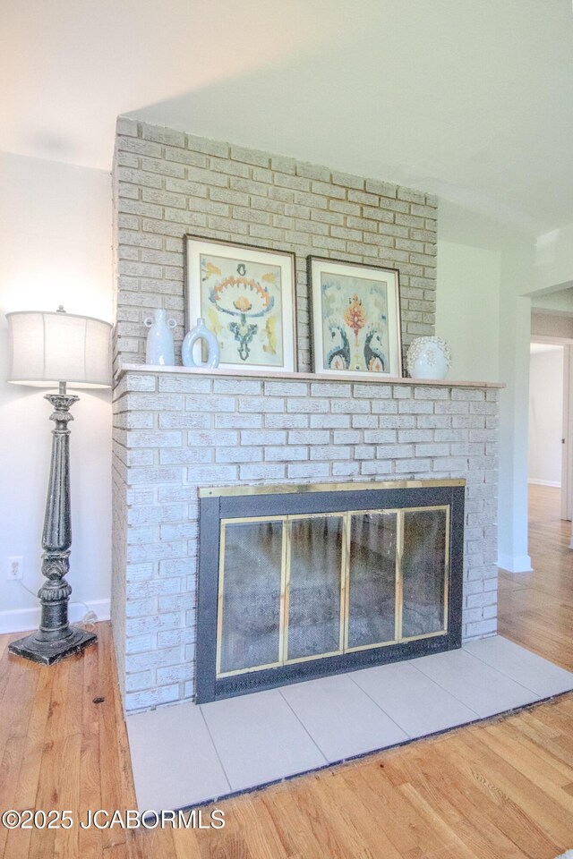 12271 County Road 4037, Holts Summit, MO 65043 - detailed view of a fireplace, wood finished floors, and baseboards