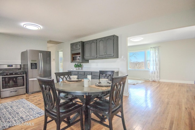 12271 County Road 4037, Holts Summit, MO 65043 - dining space featuring light wood-style flooring and baseboards