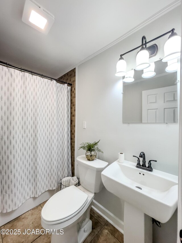 12271 County Road 4037, Holts Summit, MO 65043 - bathroom featuring toilet, tile patterned floors, a shower with curtain, ornamental molding, and a sink