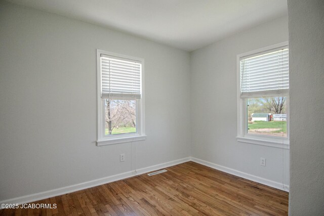 12271 County Road 4037, Holts Summit, MO 65043 - unfurnished room featuring plenty of natural light, wood finished floors, and baseboards