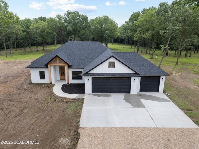 7058 County Road 409, Fulton, MO 65251 - modern inspired farmhouse featuring driveway, a garage, a shingled roof, and a front yard