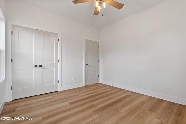7058 County Road 409, Fulton, MO 65251 - unfurnished bedroom featuring light wood finished floors, a closet, and a ceiling fan