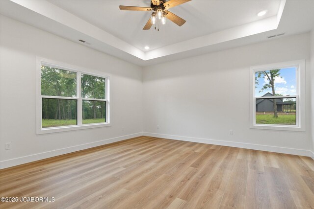 7058 County Road 409, Fulton, MO 65251 - spare room featuring a raised ceiling, light wood-style floors, recessed lighting, and a ceiling fan
