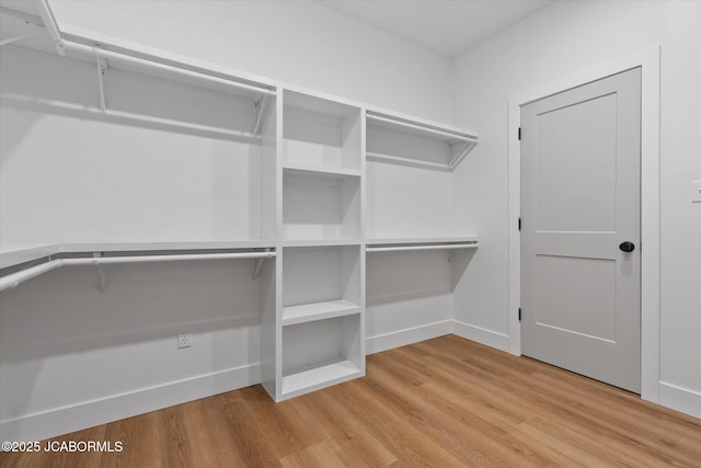 7058 County Road 409, Fulton, MO 65251 - walk in closet featuring wood finished floors
