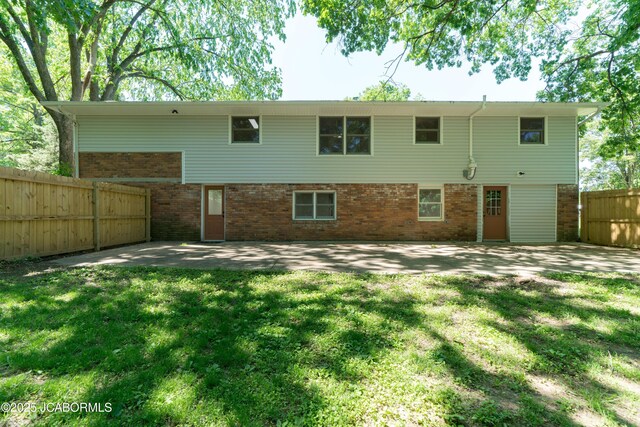 232 Pheasant Ln, Holts Summit, MO 65043 - rear view of property featuring brick siding and a patio area
