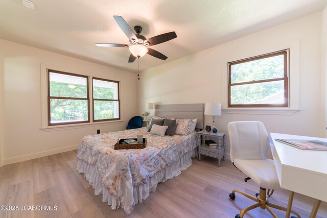 232 Pheasant Ln, Holts Summit, MO 65043 - bedroom with light wood-style floors, a desk, and ceiling fan