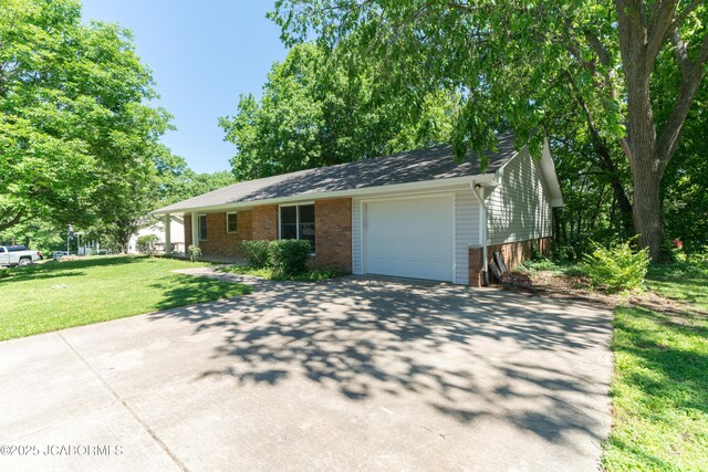 232 Pheasant Ln, Holts Summit, MO 65043 - view of front of home with brick siding, a garage, driveway, and a front yard