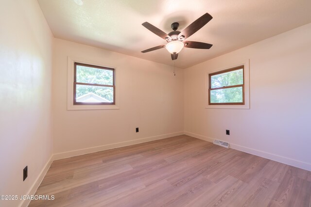 232 Pheasant Ln, Holts Summit, MO 65043 - empty room featuring healthy amount of natural light, light wood-style flooring, and ceiling fan
