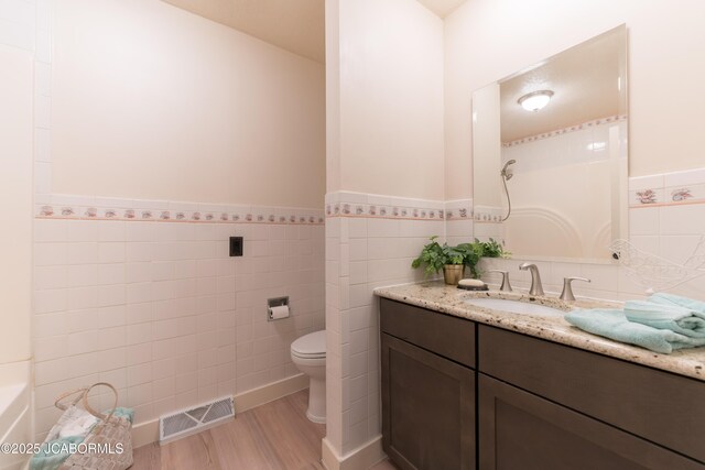 232 Pheasant Ln, Holts Summit, MO 65043 - full bathroom with tile walls, vanity, wood finished floors, wainscoting, and a shower