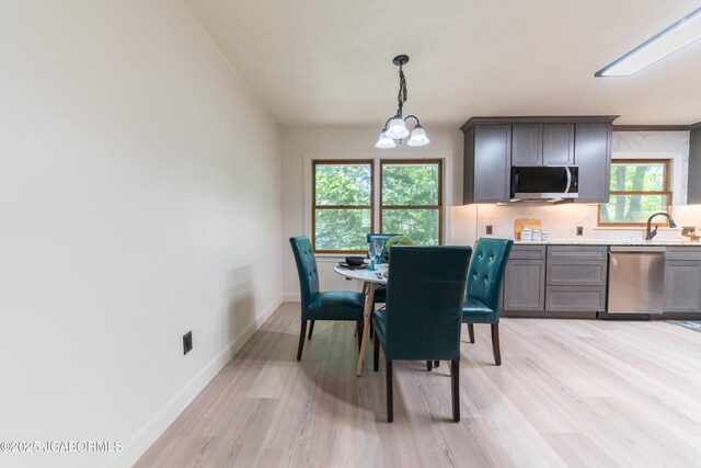 232 Pheasant Ln, Holts Summit, MO 65043 - dining room featuring light wood-style floors, plenty of natural light, and a chandelier