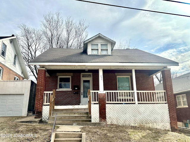 bungalow-style house with covered porch and brick siding