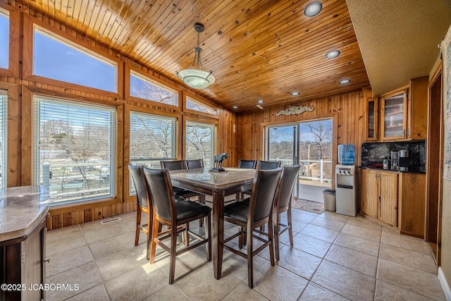 dining room featuring recessed lighting, wooden walls, vaulted ceiling, and wood ceiling