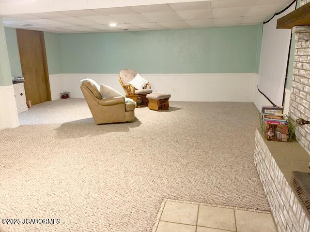 unfurnished room featuring light colored carpet and a drop ceiling