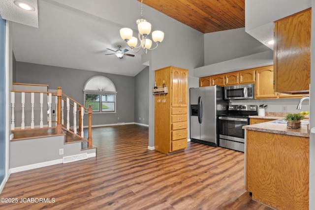 kitchen with visible vents, appliances with stainless steel finishes, a sink, ceiling fan with notable chandelier, and open floor plan